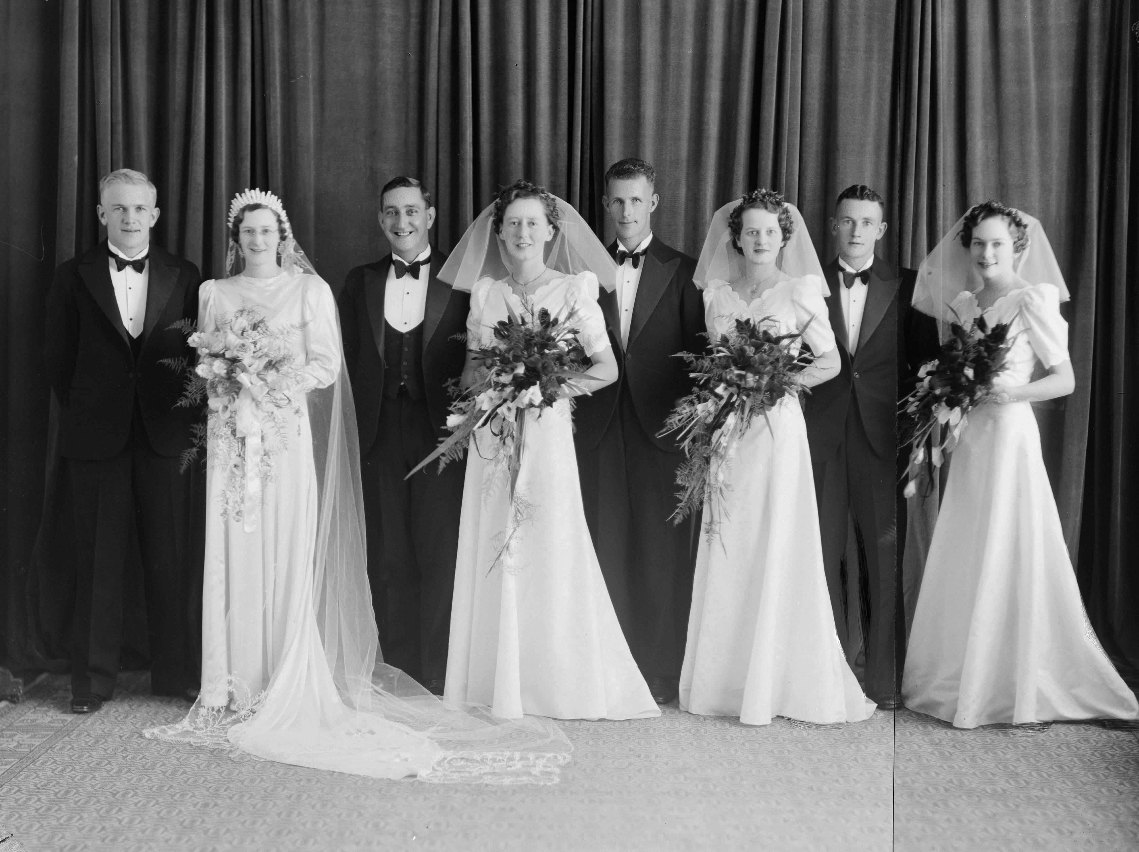 Addie Lile and Joan Franklyn standing far left on their wedding day (11 January 1938). Swainson's Studios. Collection of Puke Ariki (SW1931-1940.08004).