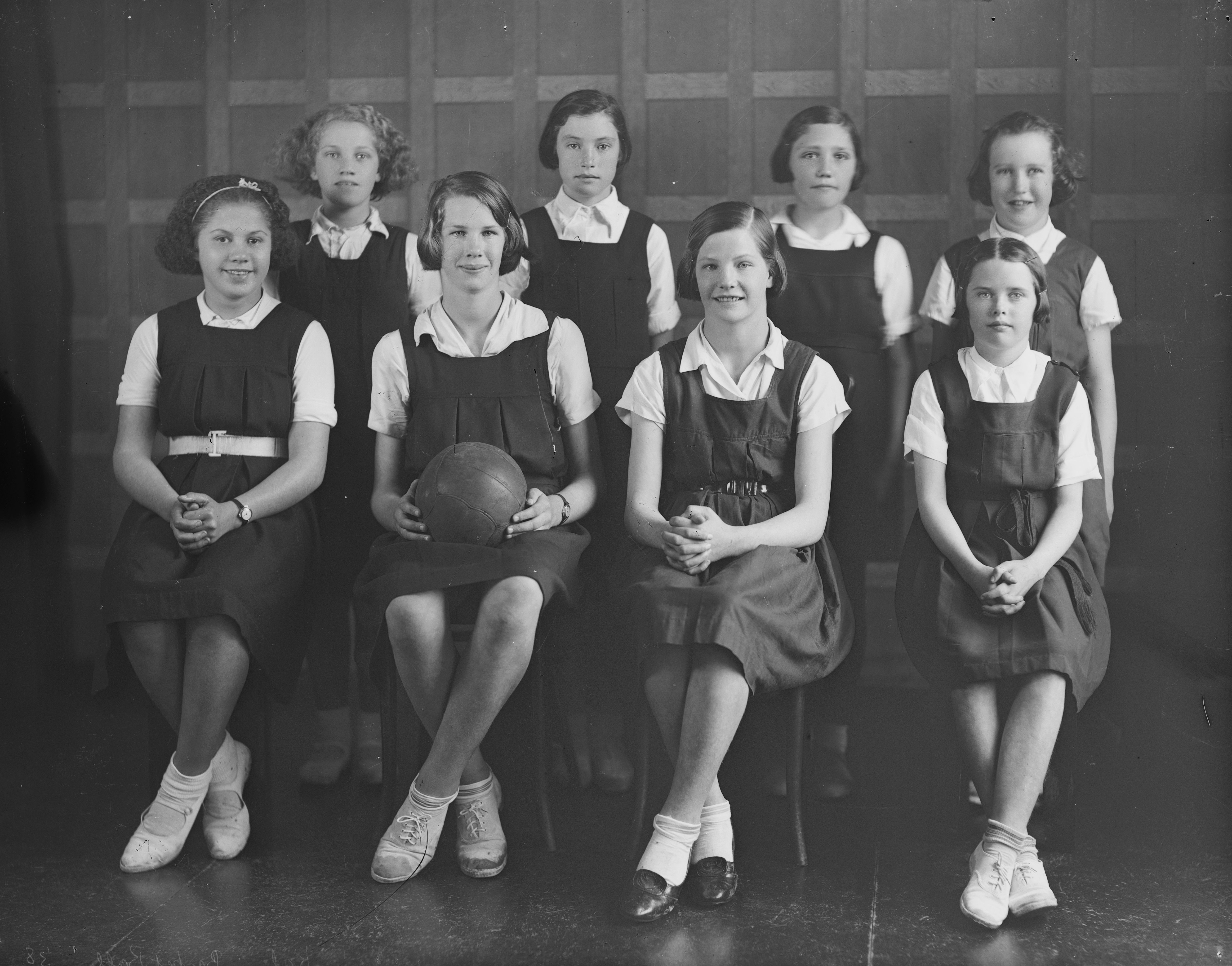 Eva Horo (far left of front row) with the rest of the Kahui School girls' basketball (netball) team (1938). Feaver Studio. Collection of Puke Ariki (GNF1578).